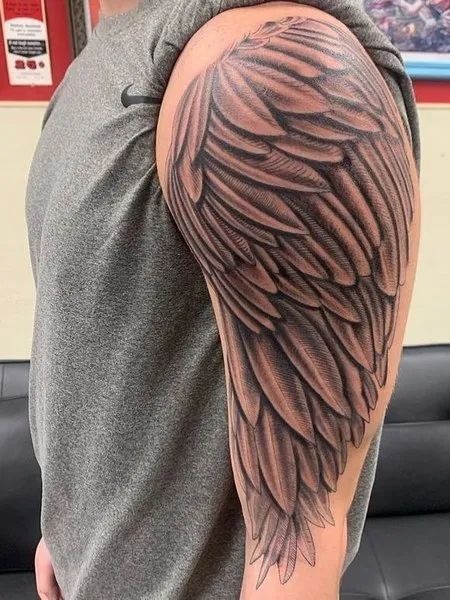 Fully covering the shoulder, this tattoo wraps with a soft, sculptural grace.