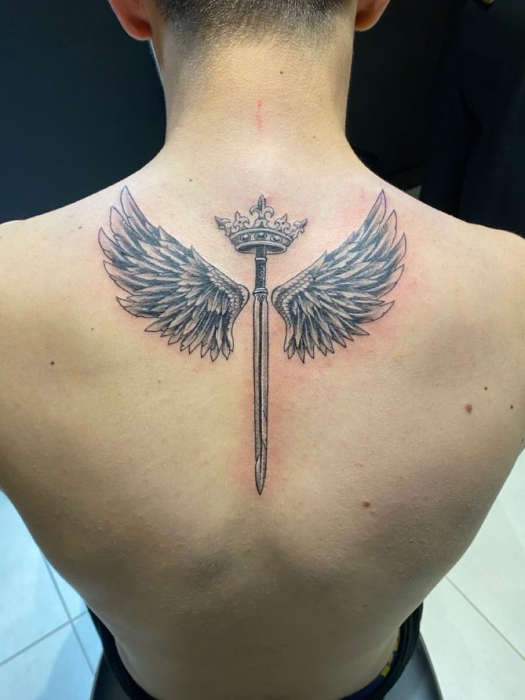 This powerful piece merges celestial and royal imagery, a sword crowned at the hilt with wings stretching outward.