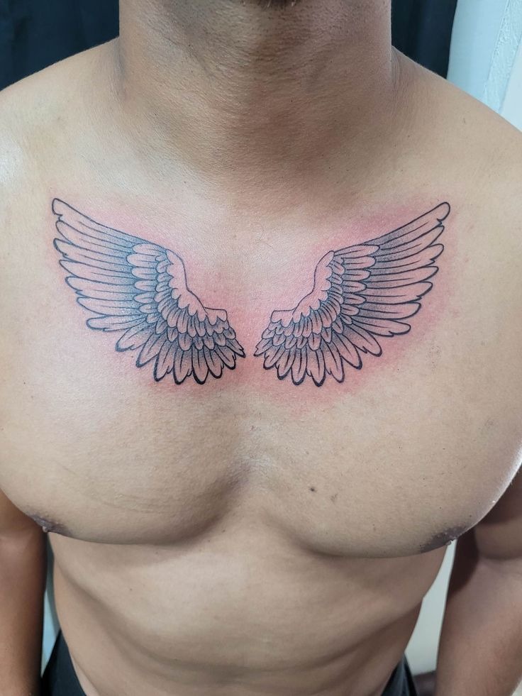 This angel wings tattoo on chest is clean, airy, and smartly spaced.
