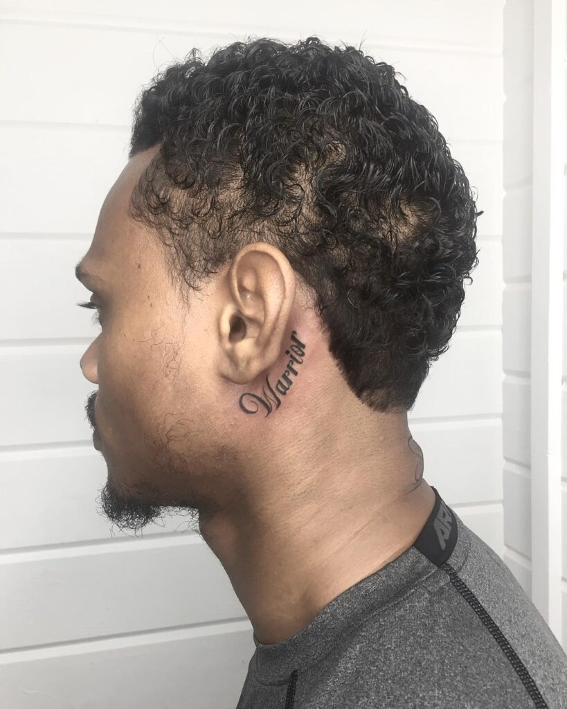 Vertical “Warrior” Script Behind the Ear Tattoo Design