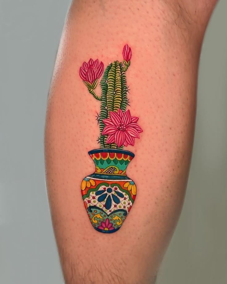 A vivid burst of color and culture, this tattoo features a blooming cactus in a Mexican Talavera-style vase.