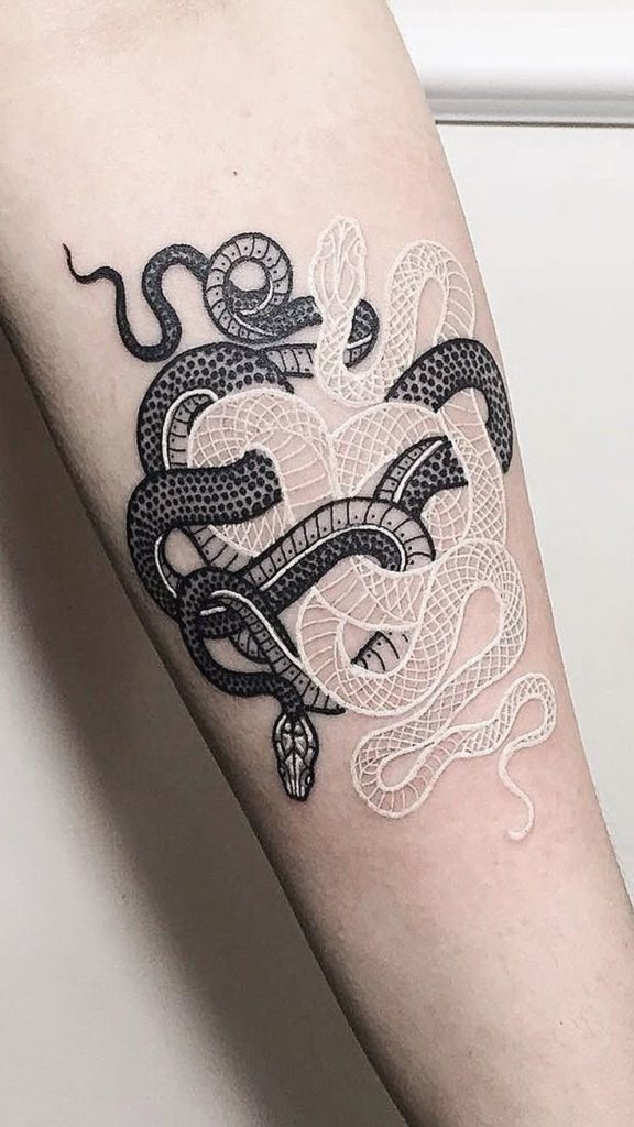 This mesmerizing tattoo is a study in contrast, intertwining black and white snakes in a looping, knotted formation.