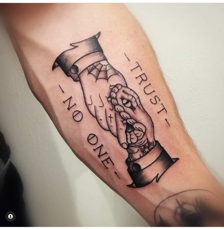 Featuring two clasped hands, one seemingly human, the other stitched and zombified, this tattoo is both edgy and introspective.