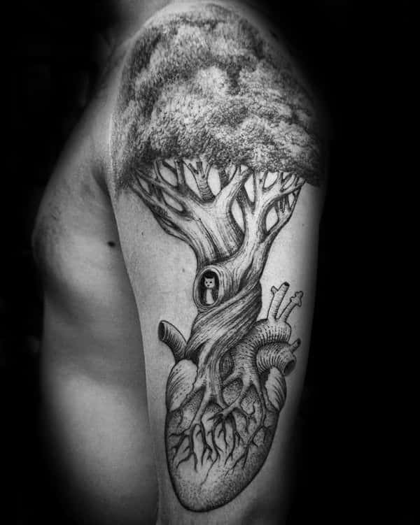 This striking upper arm tattoo features an anatomical heart with a large tree growing from its top.