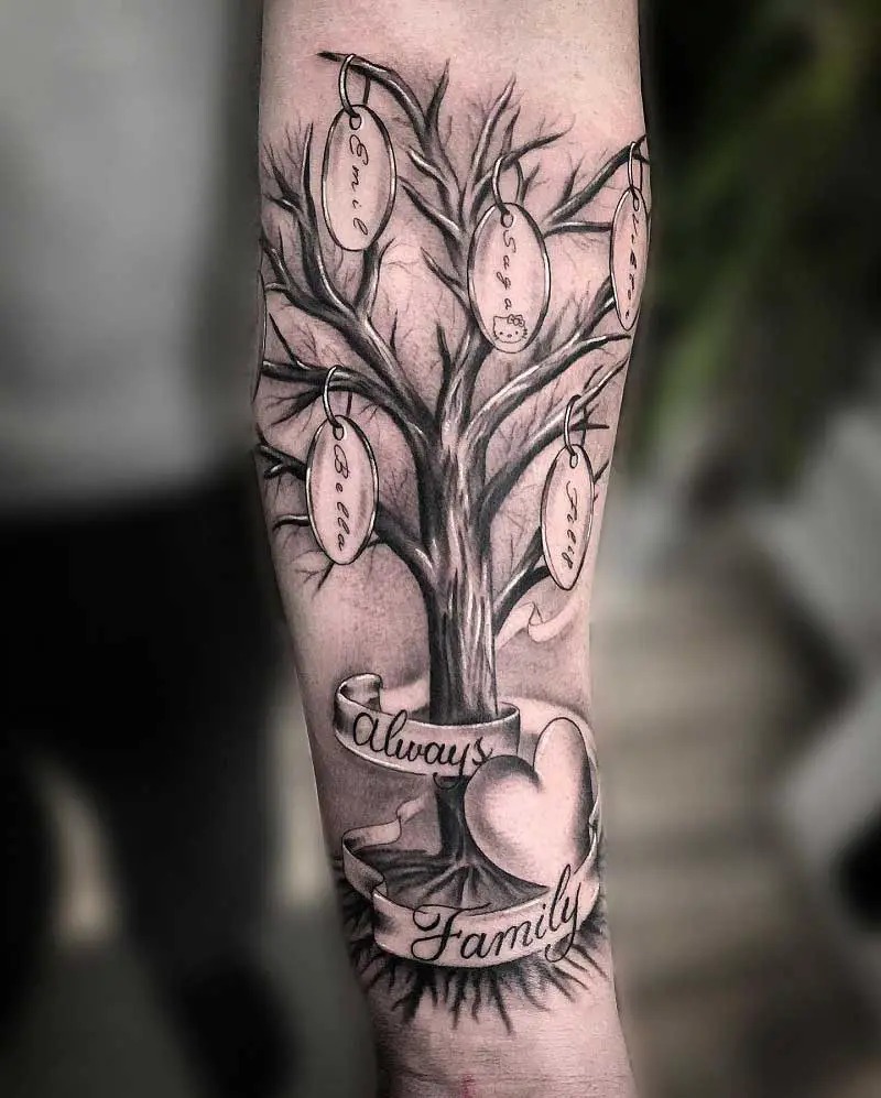 On the forearm, this simple yet powerful tattoo features a tree with bare branches, allowing space for the hanging name tags of family members.