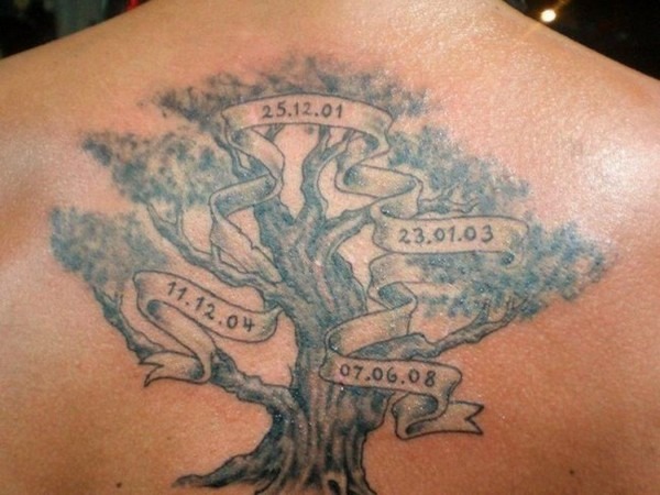 This back tattoo showcases a large family tree with banners displaying important dates like 25.12.01 and 23.01.03.