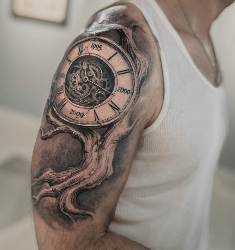 On the upper arm, this tattoo combines a family tree with a clock face, representing the passage of time.