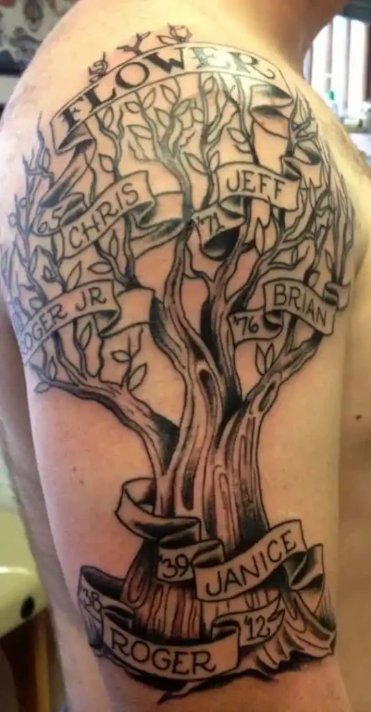 This large shoulder tattoo features an intricately designed tree with banners displaying both names and birth years, such as Chris, Jeff, Roger Jr., and Brian.