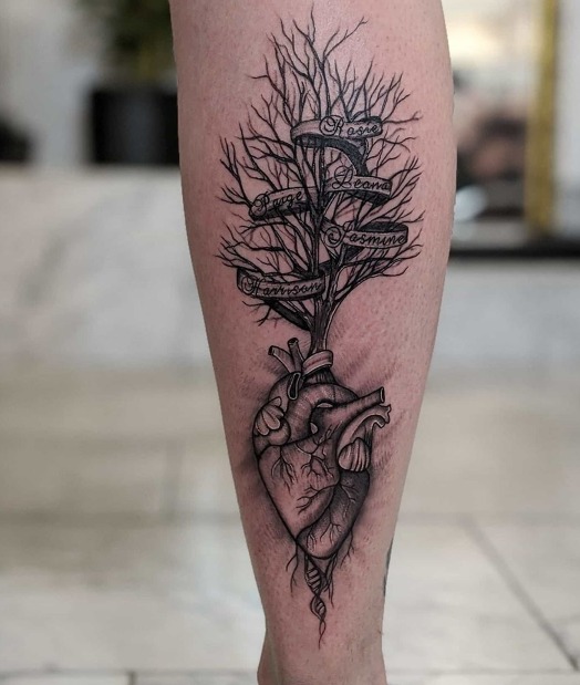 This calf tattoo combines a detailed anatomical heart with a family tree growing from its valves.