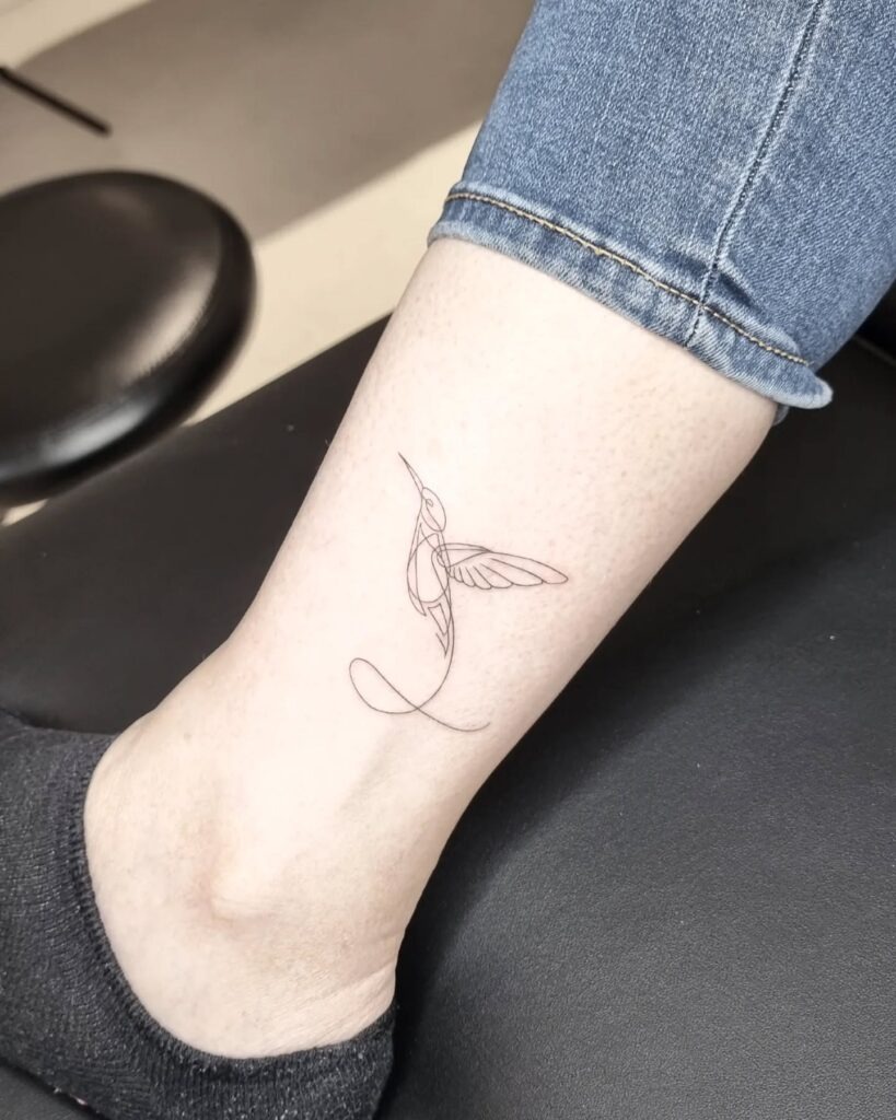 Fine Line Hummingbird on Upper Arm Tattoo Design