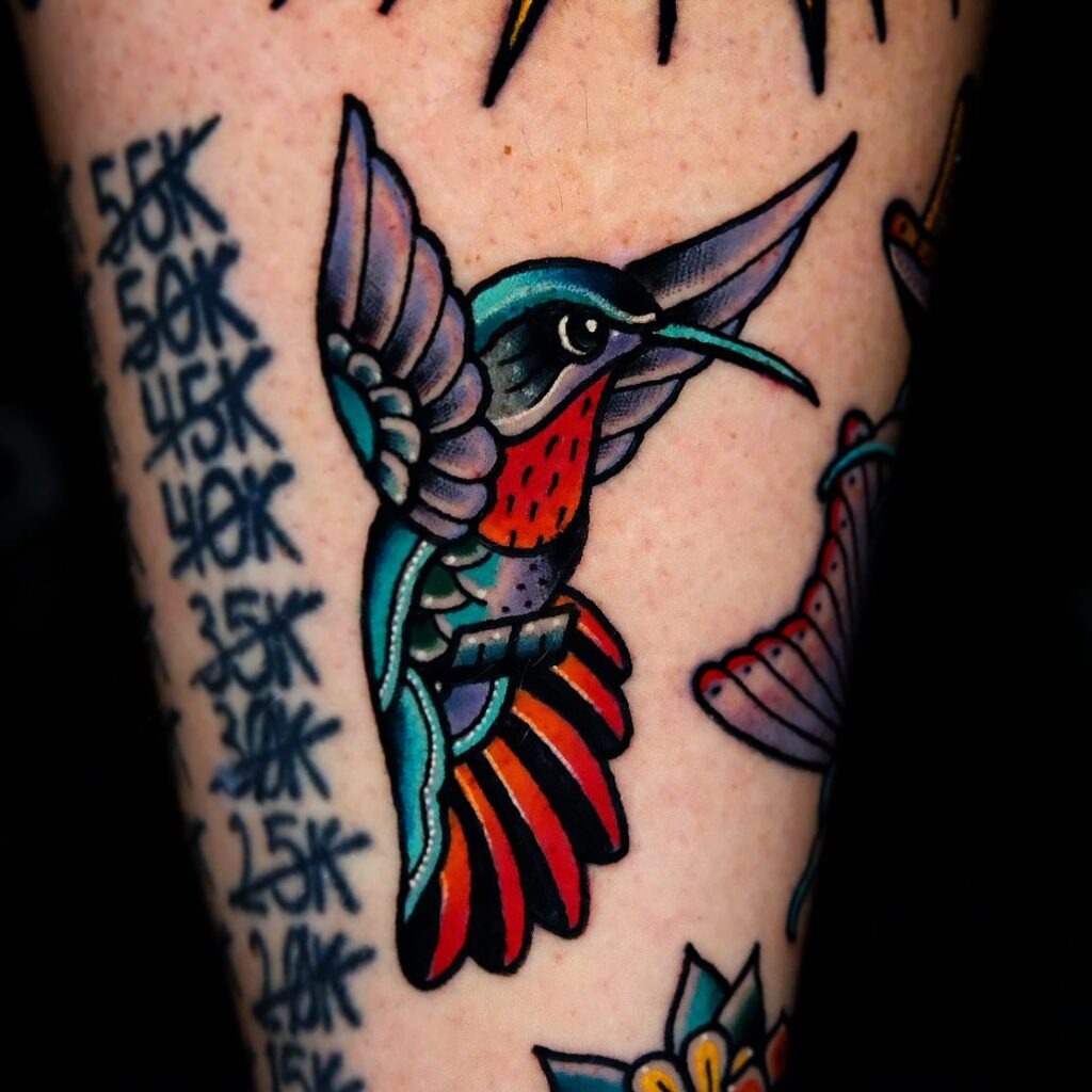 Hummingbird with a Flower Tail on Collarbone Tattoo Design