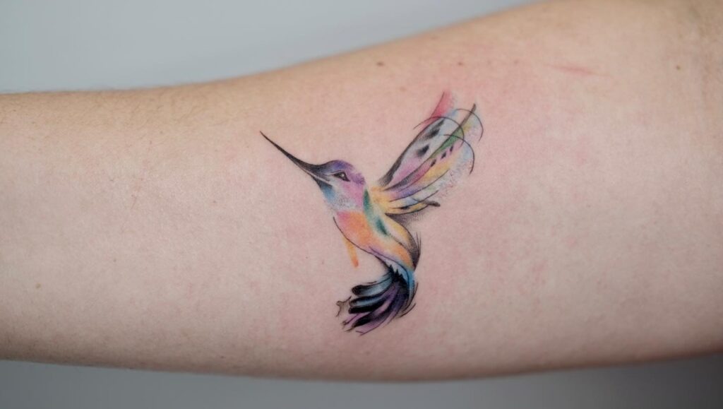Hummingbird with Colorful Botanical Scatter Tattoo Tattoo Design