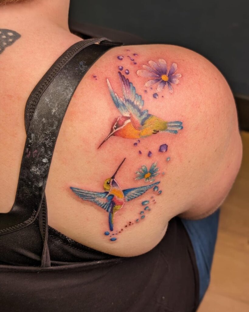 Vibrant Watercolor Hummingbird on Thigh Tattoo Design