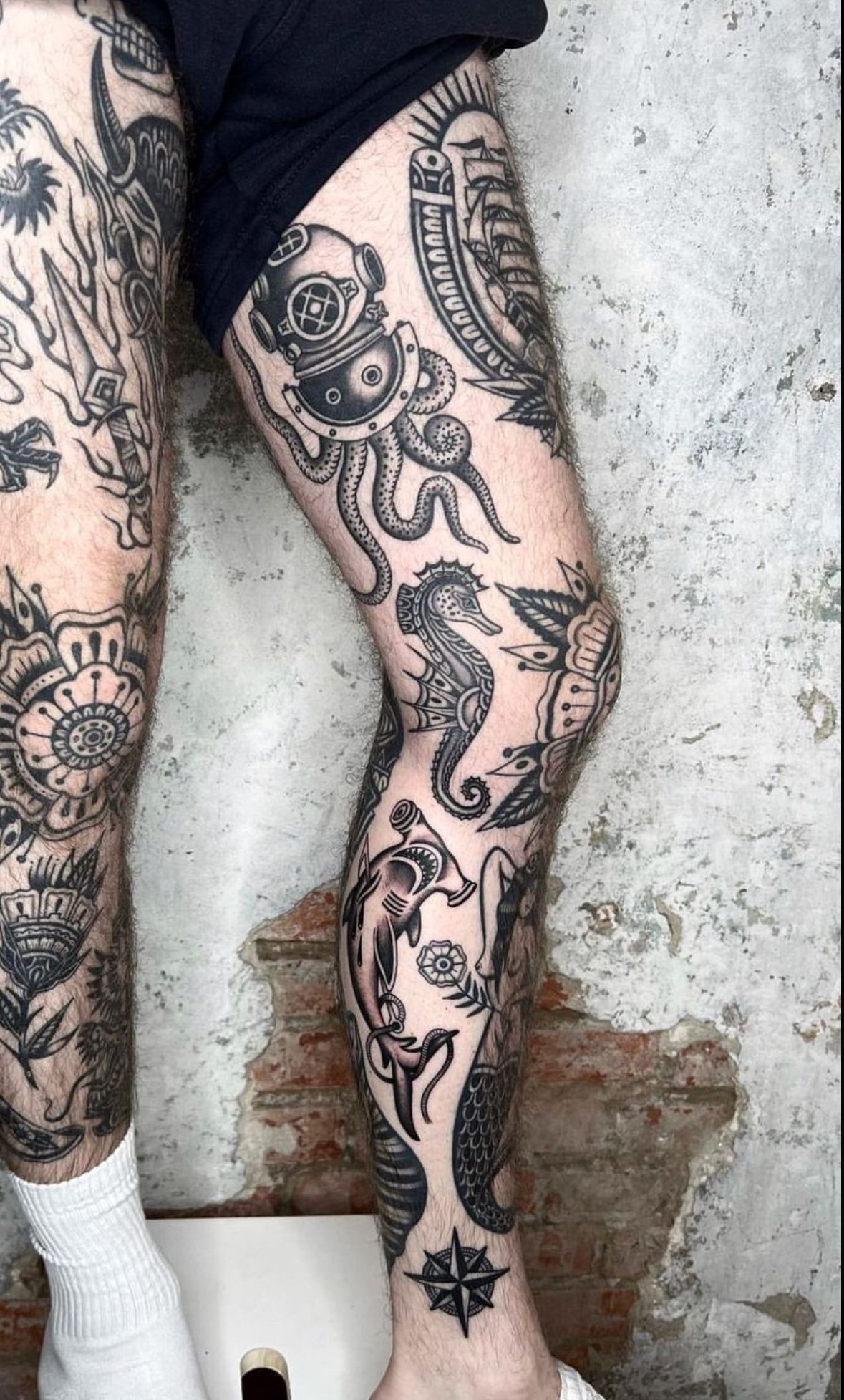 Nautical-Themed Storyline Thigh Tattoo, a tattoo design rendered in clean detailed linework for the sleeve.