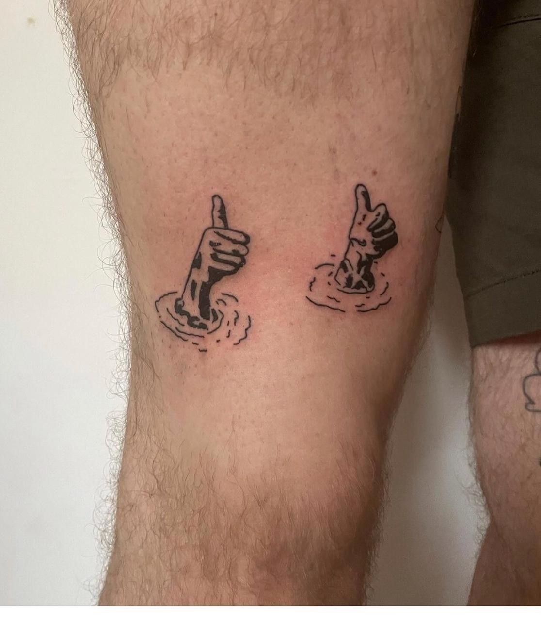 Sunk or Safe? Double Thumbs, a tattoo design rendered in clean detailed linework for the thigh.