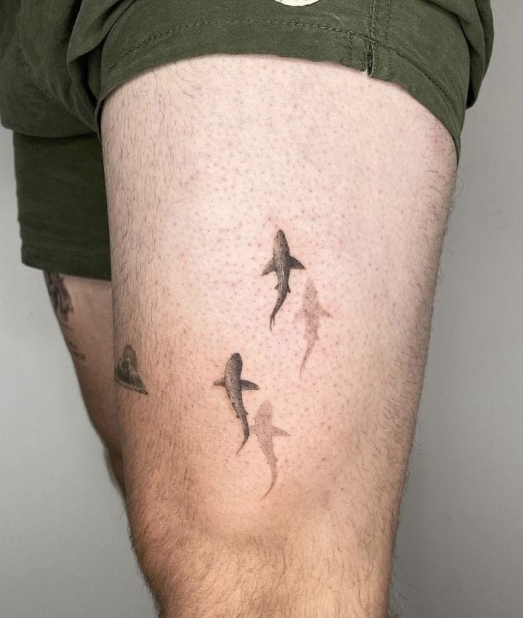 Trio of Ghosted Sharks, a tattoo design rendered in clean detailed linework for the thigh.