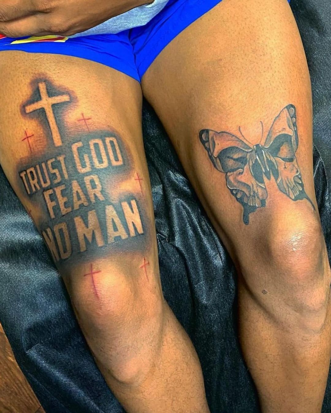 Trust God, Fear No Man Statement Tattoo, a tattoo design rendered in bold for the thigh.