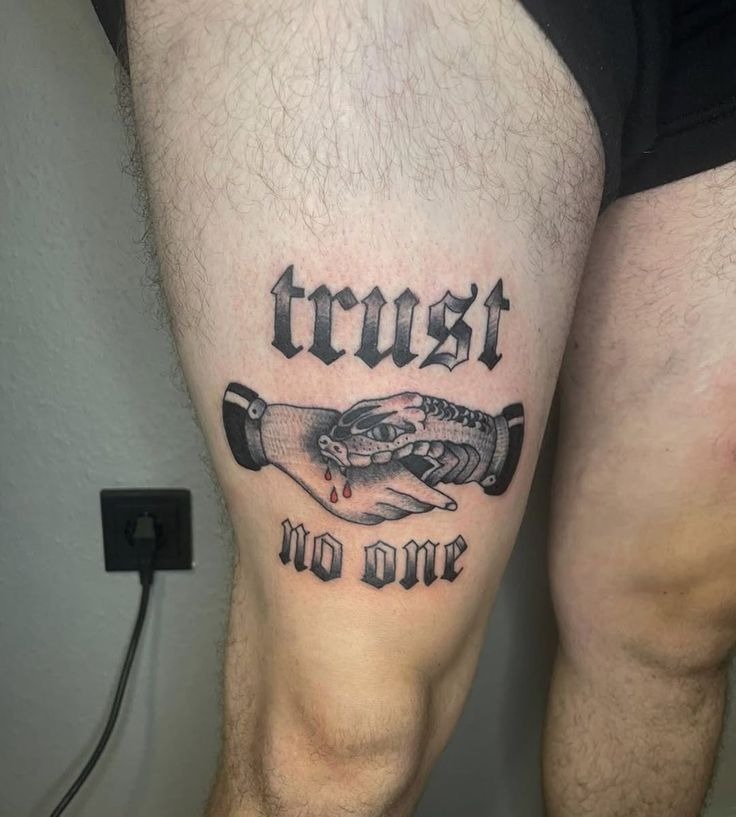 Trust No One Banner, a tattoo design rendered in bold traditional for the thigh.