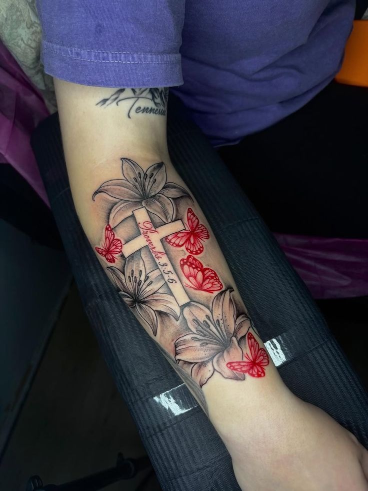 Cross, Lilies, and Red Butterfly Accents Tattoo Design