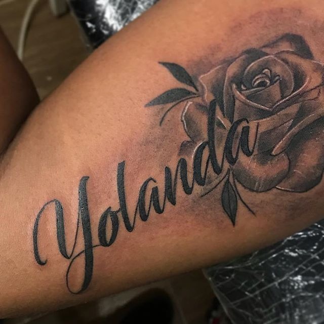 Floral Accents with a Bold Signature Tattoo Design