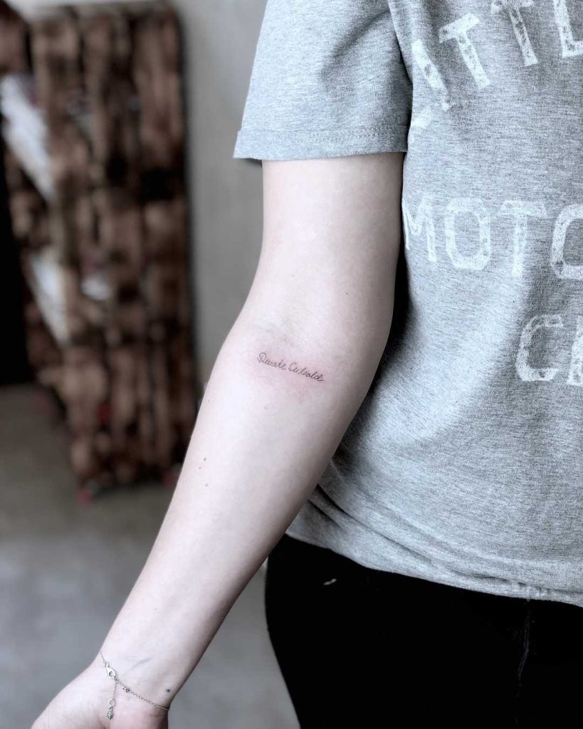 Subtle Elegance in Minimalist Script Tattoo Design