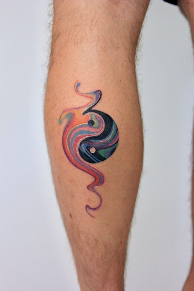 A brilliant tattoo blends traditional yin-yang symbolism with blue, purple, and red swirls that express complete attitude.