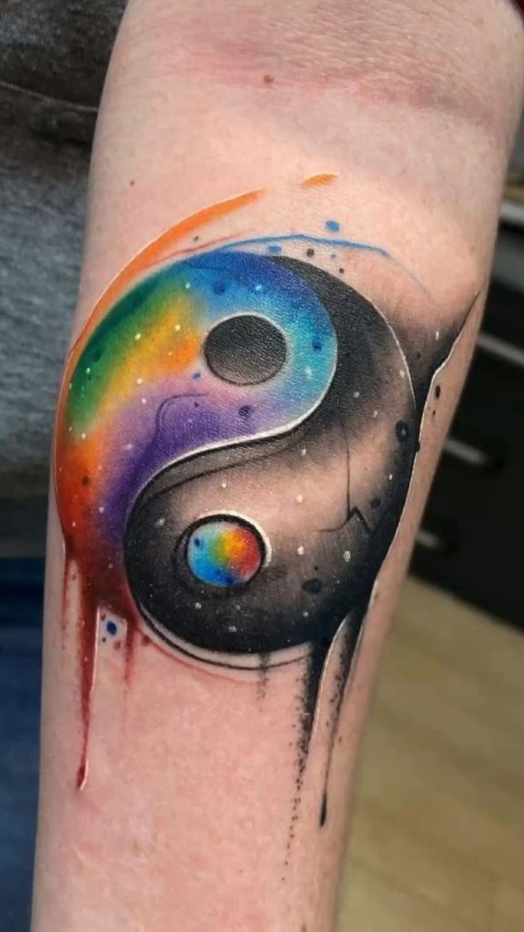 The design centers on cosmic rainbow yin yang imagery that reads clearly at a glance.