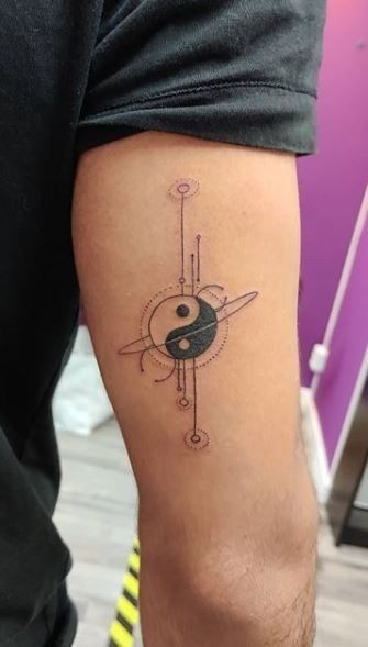 The tattoo combines geometric shapes with space elements that could be straight out of a science fiction drawing.