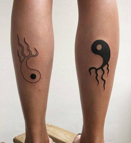 The alternative yin-yang design across two calves creates symbolic tentacles or flames extending from each side.