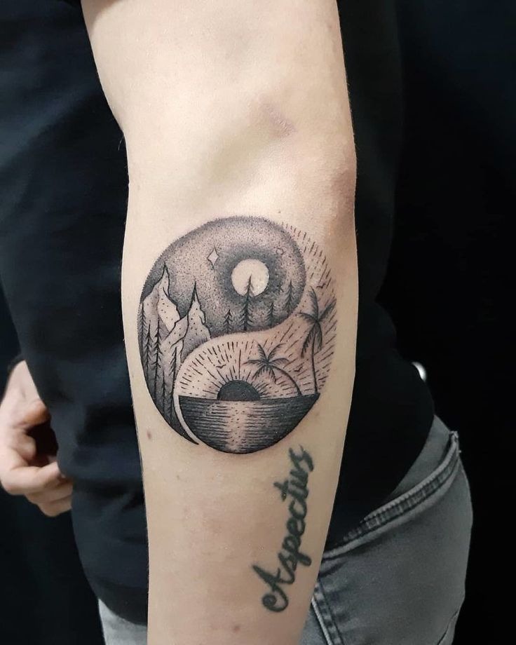 The yin-yang symbol of this tattoo supports a complete story, pointing to mountain peaks lit by stars on one side and a sunset illuminating a tropical beach scene on the other.