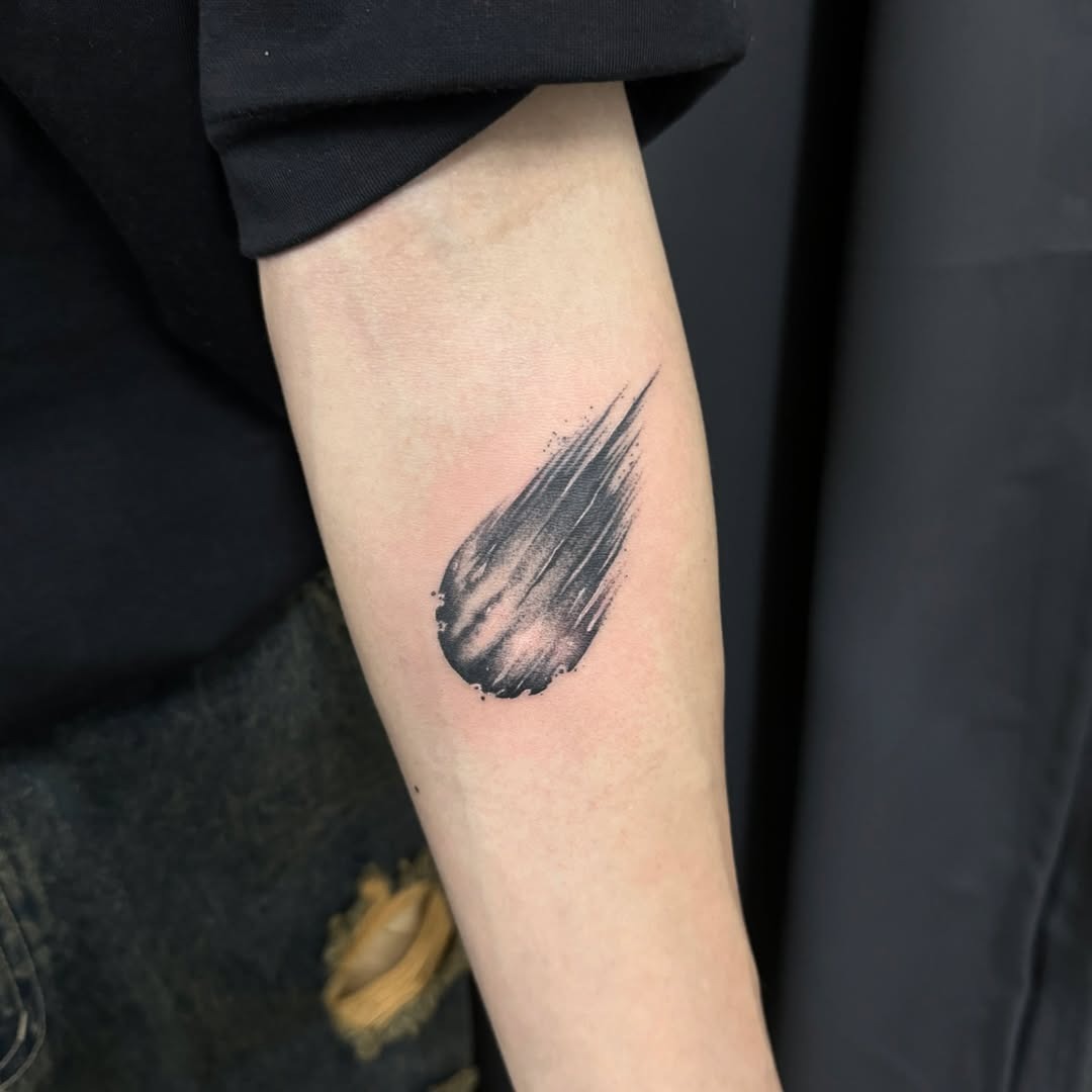 This meteor tattoo captures the essence of movement with a sleek design.