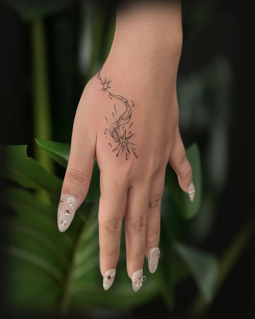 This tattoo features a beautifully elegant meteor design inked in black.