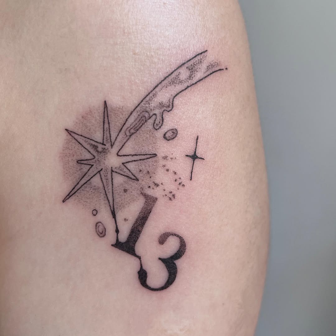 This tattoo features a sleek meteor with a striking star and the number 13.