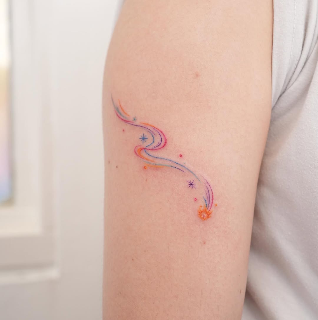 This colorful meteor tattoo features a dynamic swirl of hues, evoking a sense of movement and energy.