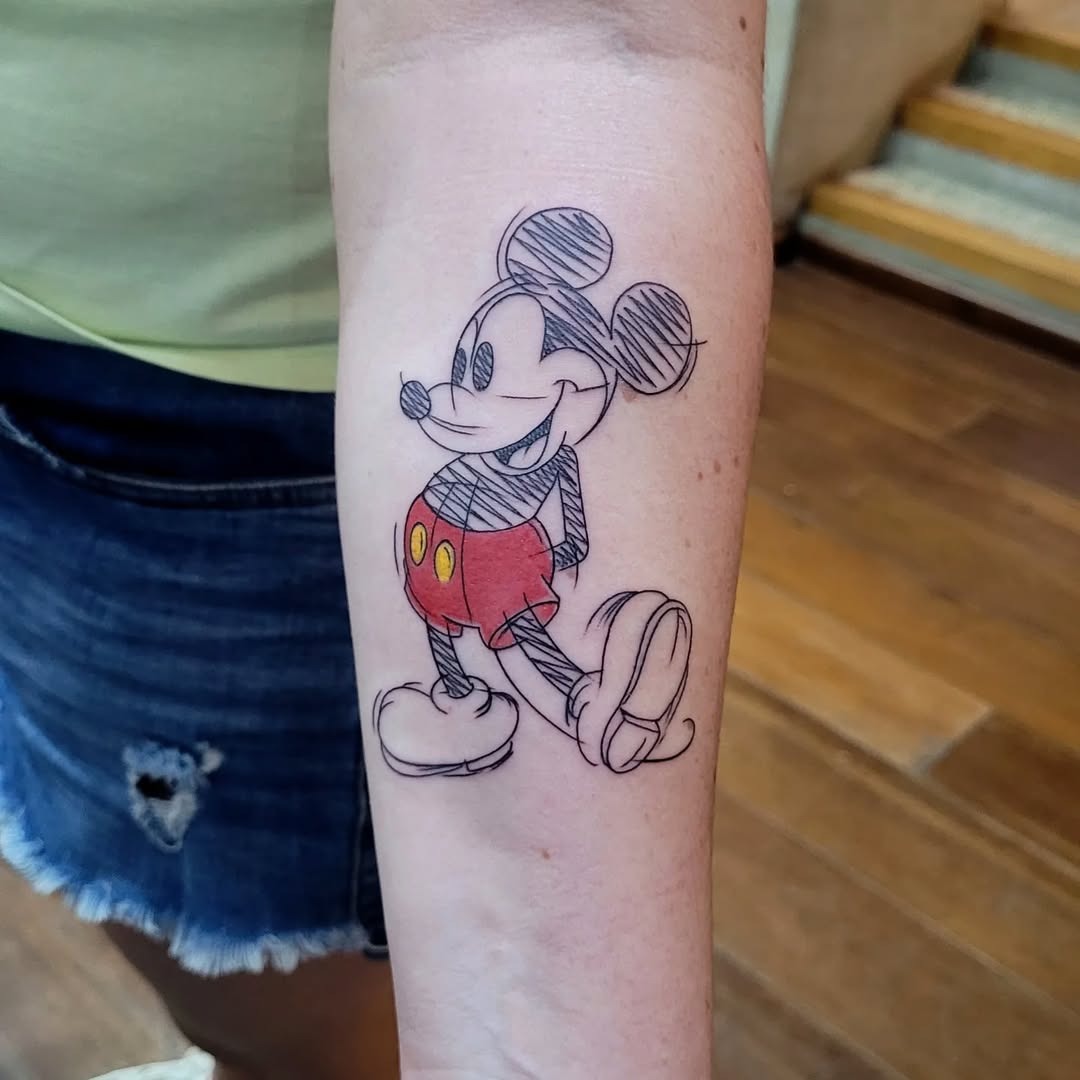 This tattoo showcases a fun, sketch-style Mickey Mouse.