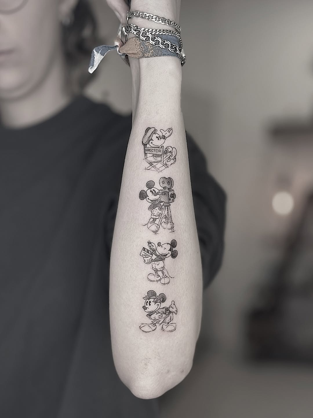This image showcases a variety of classic Mickey Mouse tattoos on an arm.