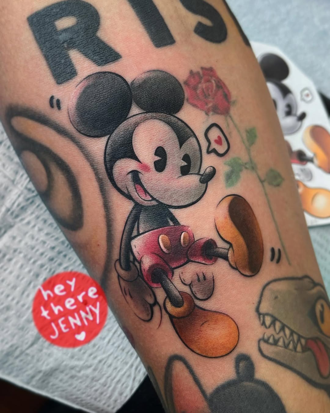 This tattoo showcases a delightful Mickey Mouse, complete with his iconic ears and a playful pose.