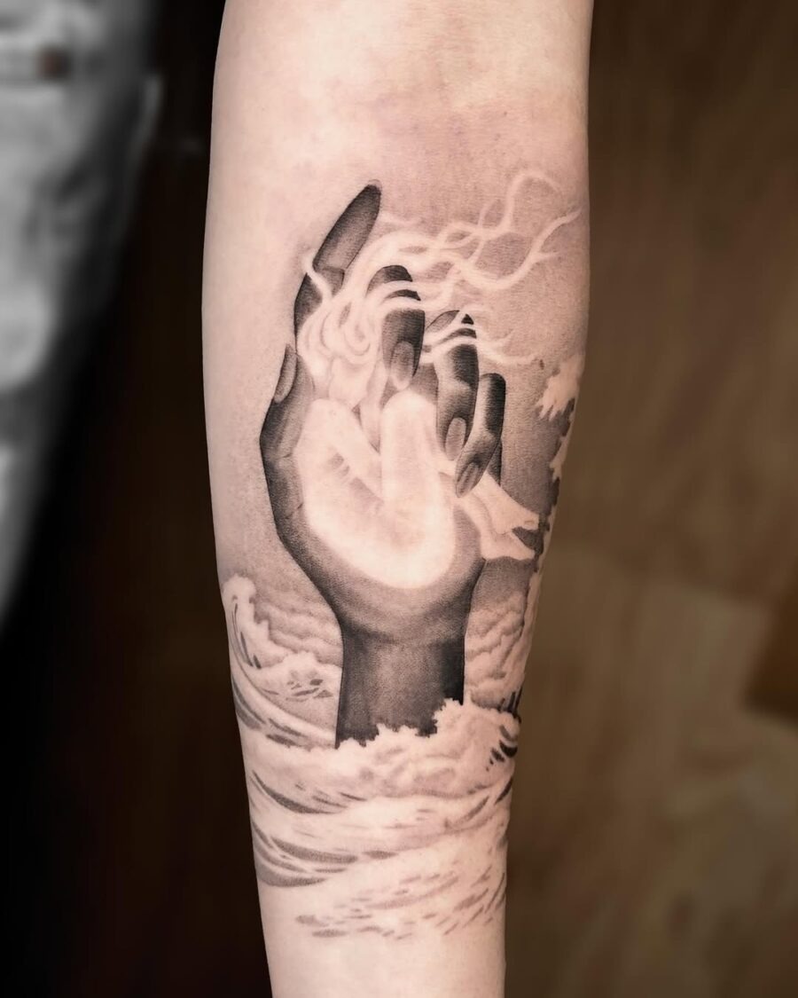 Serene hand emerging from waves and clouds Tattoo Design