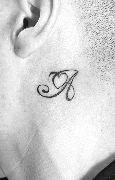 A delicately placed letter A behind the ear combines the allure of a hidden tattoo with the romance of cursive styling.