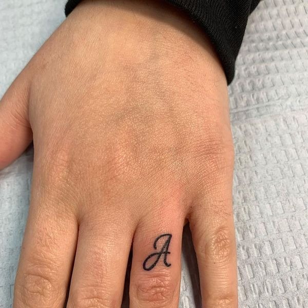 Placing a single, cursive letter A on the finger makes for a truly hidden and intimate tattoo choice.
