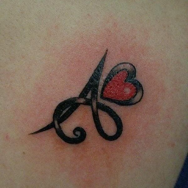 Combining a stylized letter A with a red heart, this tattoo is rich in design and emotion, located near the shoulder.