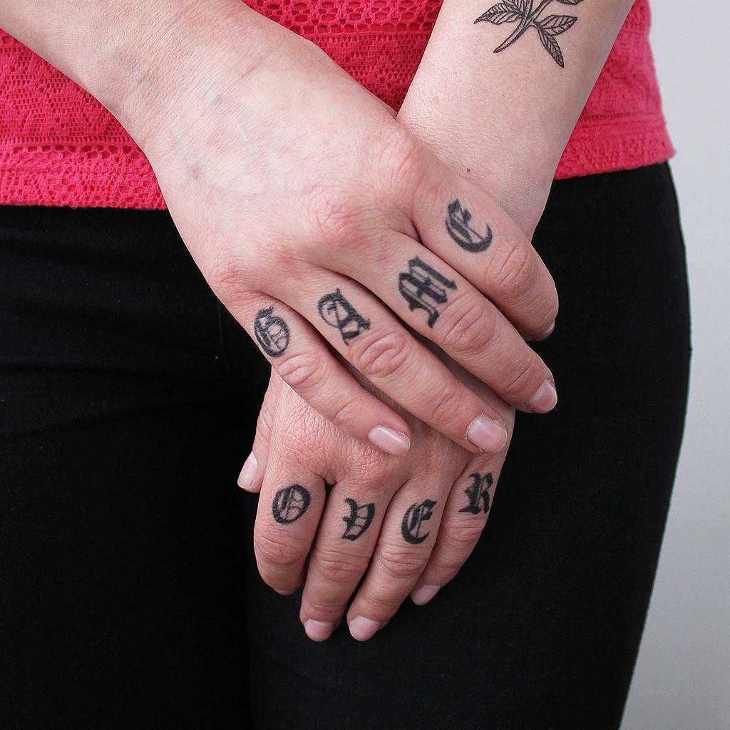 Here, each finger is adorned with a different initial, creating a compelling narrative across both hands.