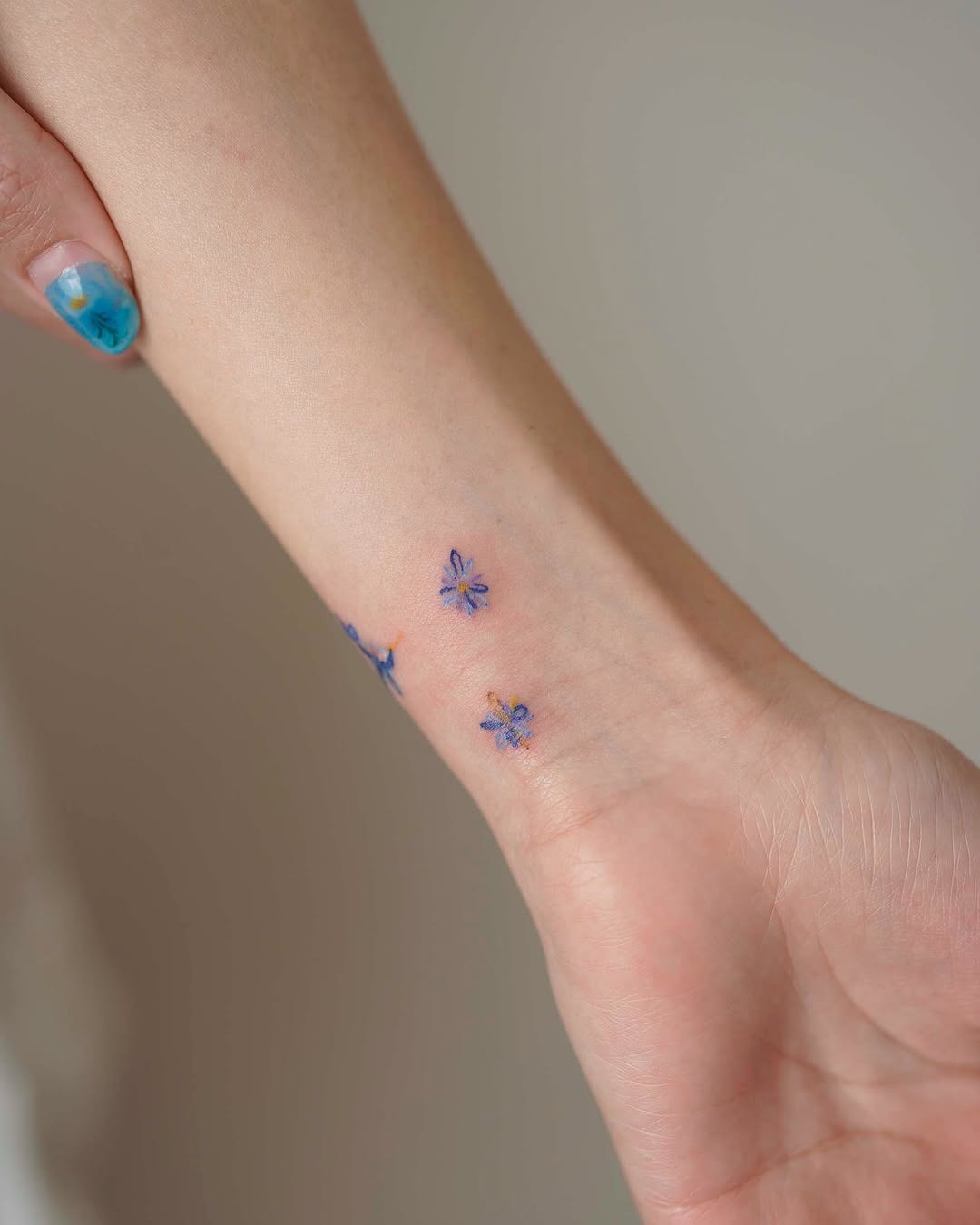 Delicate floral ink on a wrist for charm Tattoo Design