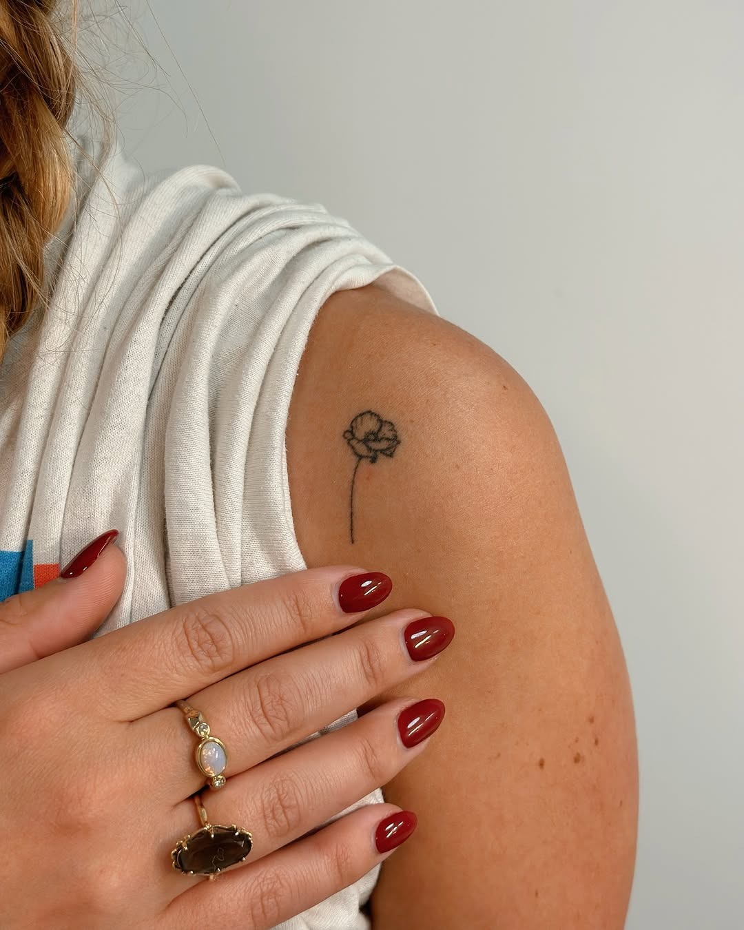 Delicate minimalist flower tattoo on shoulder Tattoo Design