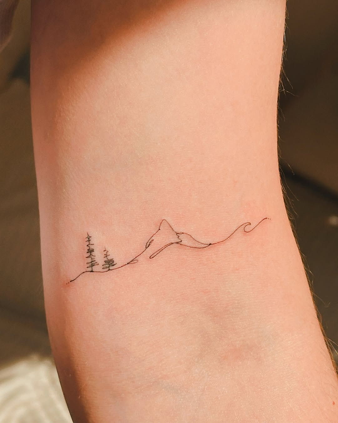 Delicate mountain and wave minimalist tattoo Tattoo Design