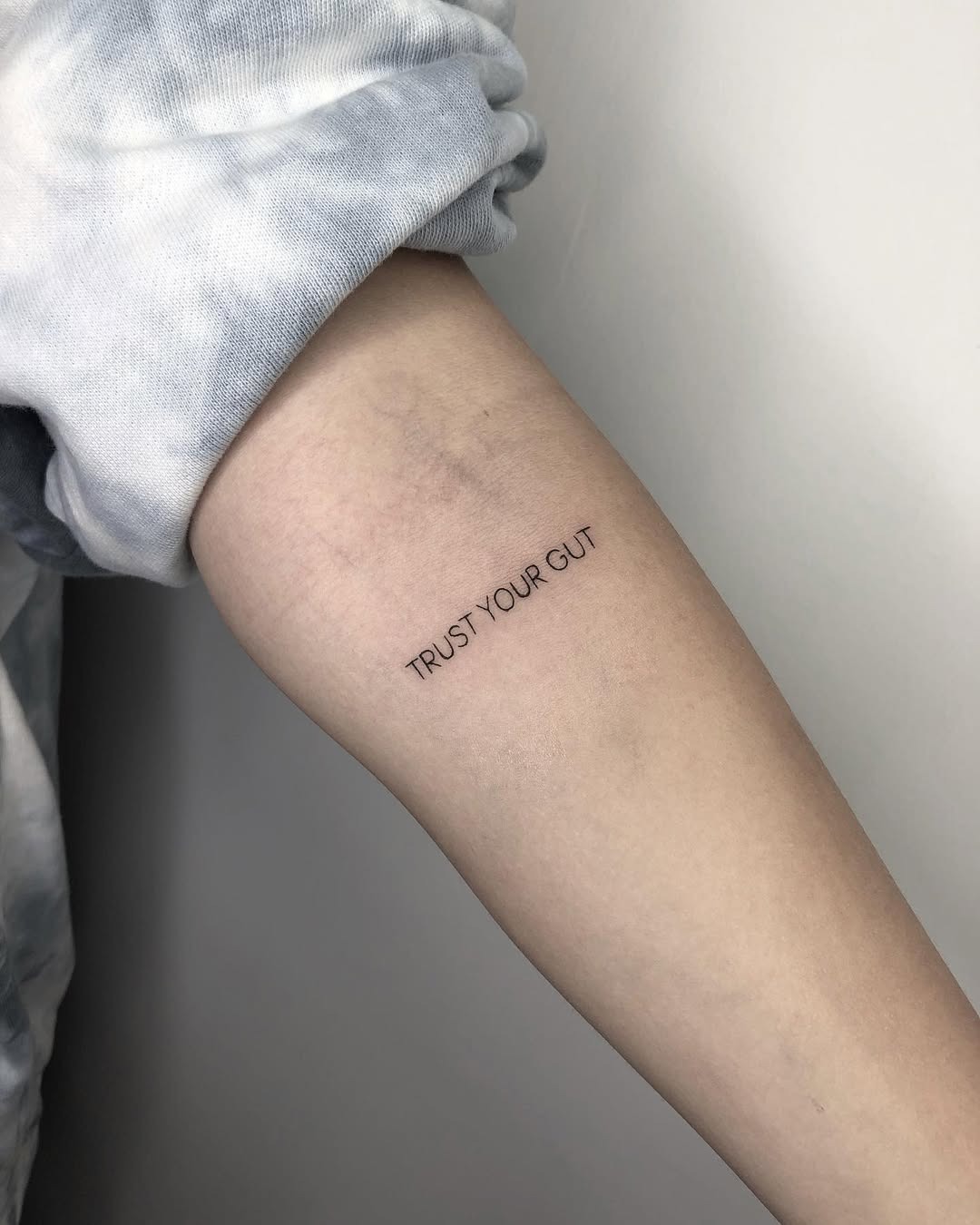 Simple text tattoo conveying strong intuition Tattoo Design