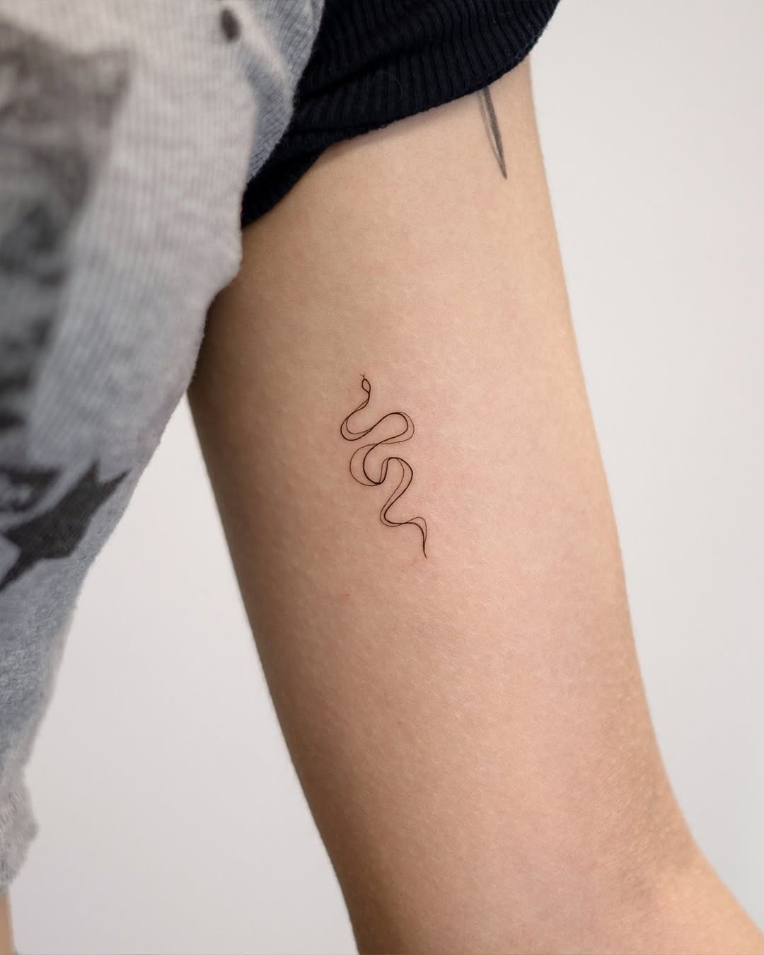 Sleek and simple minimalist snake tattoo Tattoo Design