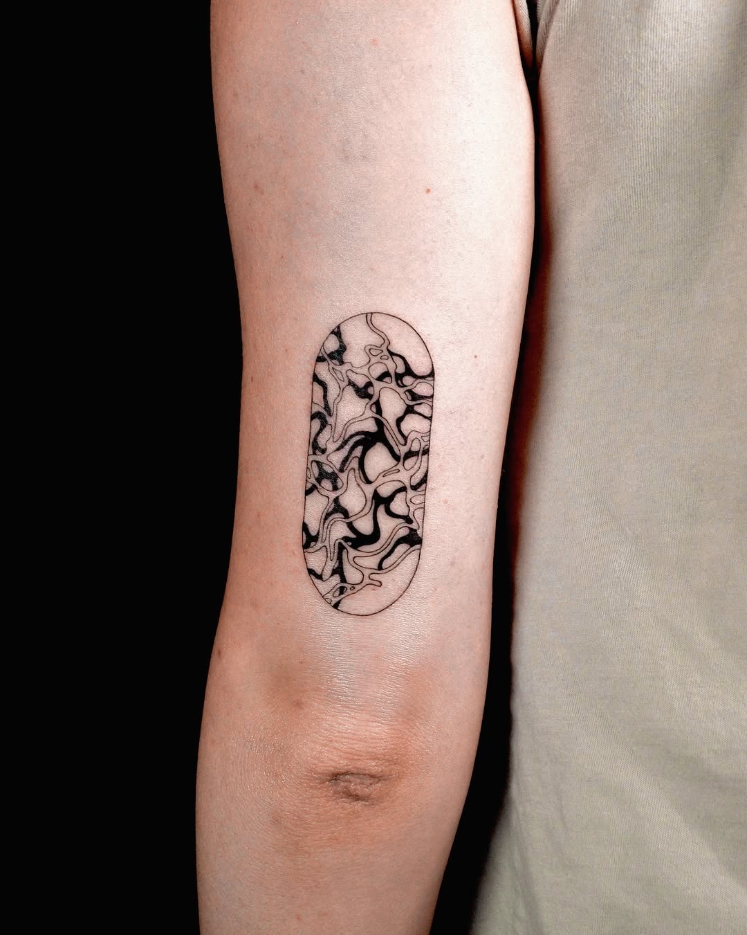 Sleek marbled effect tattoo on forearm Tattoo Design