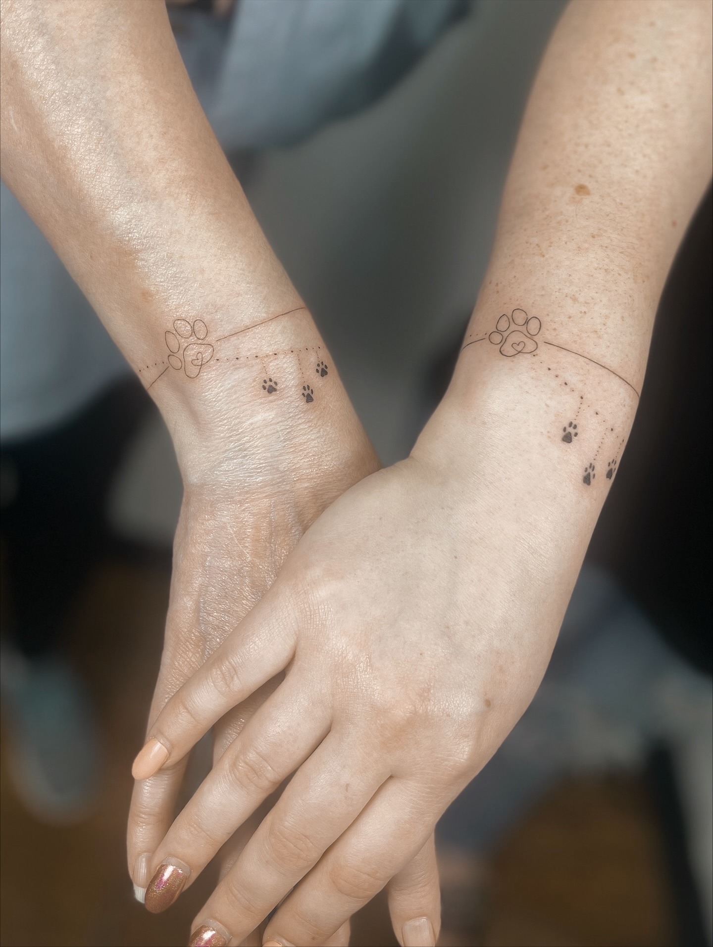 Matching Fine Line Paw Print Bracelet Tattoos for Mom and Daughter Tattoo Design