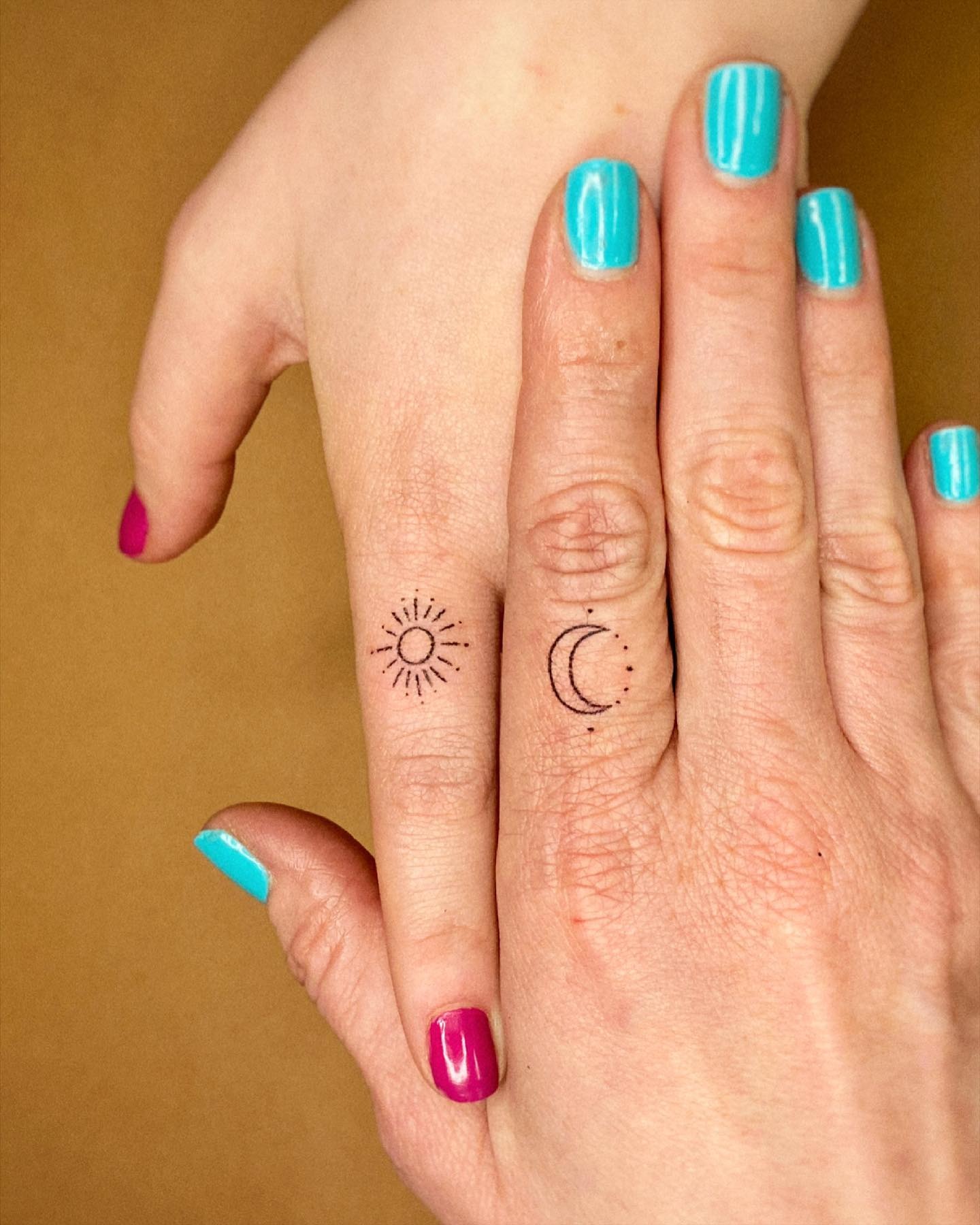 Matching Sun and Moon Finger Tattoos for Mother and Daughter Tattoo Design